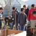 Karl Ivanov, president of I & E Construction, shows Molalla High School Culture Club members how to prepare garden beds (Photo by Kelly Douglas)